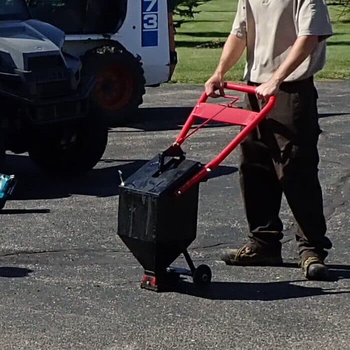 Hot pour crack sealant applied from a pour pot