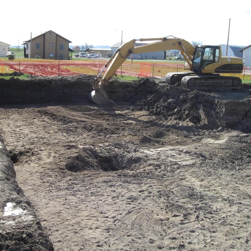 A finished foundation hole with cut earth walls and a level bottom
