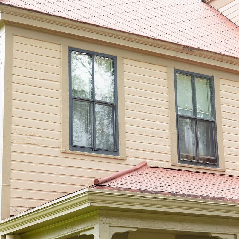 Freshly painted wood siding with crisp white trim