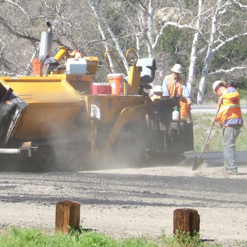 Paver laying a hot mix asphalt mat
