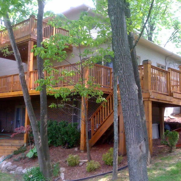 A cedar deck freshly stained, the boards and railings glowing in the sun