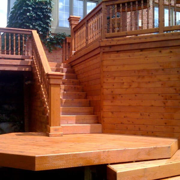 Freshly stained deck stairs and a landing with matching stained railings